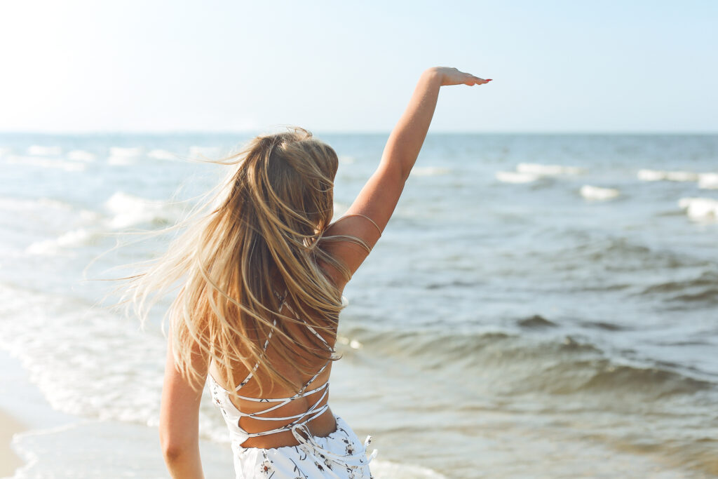 Zdjęcie dziewczyny w letniej sukience nad morzem