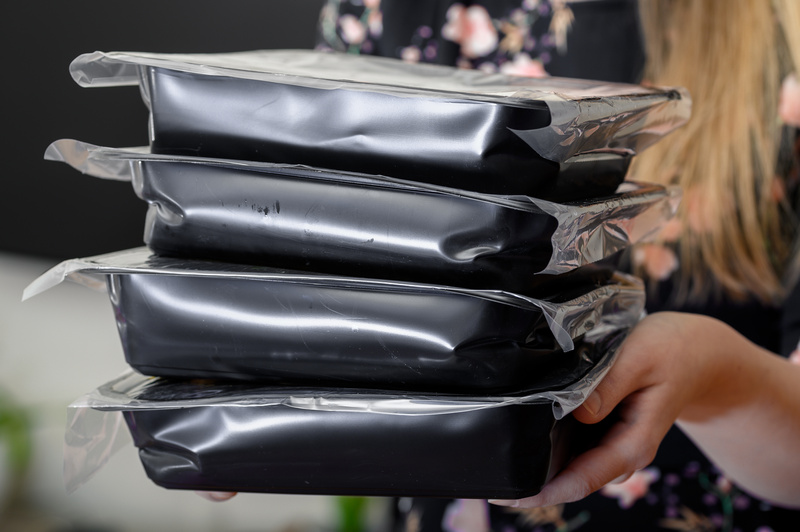 Kobieta dostarczająca jedzenie w plastikowych opakowaniach
