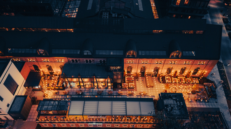 Widok z lotu ptaka warszawskich ogródków restauracyjnych podświetlonych nocą