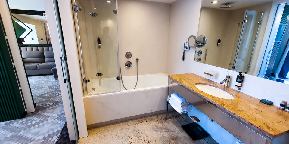 Łazienka w apartamencie posiada wannę z prysznicem