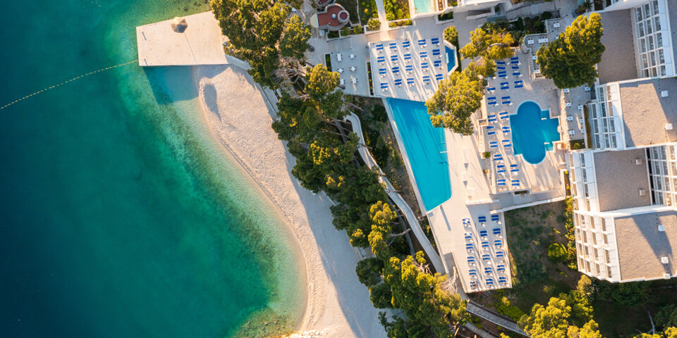 Tylko drzewa sosnowe oddzielają hotel od Adriatyku